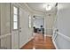 Inviting foyer with hardwood floors, a bright white door, and a view into the home office at 908 Huntington Pl, Peachtree City, GA 30269