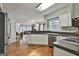 Modern kitchen with stainless steel appliances, hardwood floors and granite countertops at 908 Huntington Pl, Peachtree City, GA 30269