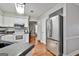 Bright kitchen with stainless steel refrigerator, hardwood flooring, and ample cabinet space at 908 Huntington Pl, Peachtree City, GA 30269