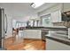 Bright kitchen with white cabinets, stainless steel appliances, and hardwood floors at 908 Huntington Pl, Peachtree City, GA 30269
