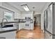 Updated kitchen featuring stainless steel appliances, stylish white cabinetry, and hardwood floors at 908 Huntington Pl, Peachtree City, GA 30269