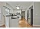 Well-lit kitchen featuring white cabinets, stainless steel appliances, and hardwood floors at 908 Huntington Pl, Peachtree City, GA 30269