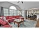 Inviting living room with large windows, vaulted ceilings, and a comfortable red sectional sofa at 908 Huntington Pl, Peachtree City, GA 30269
