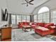 Cozy living room featuring a large window, a ceiling fan, and a comfortable red sofa at 908 Huntington Pl, Peachtree City, GA 30269
