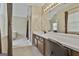 Bathroom with vanity and sinks leading into a tub and shower at 908 Huntington Pl, Peachtree City, GA 30269