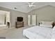 Bright main bedroom featuring carpet floors and a view of an adjacent room at 908 Huntington Pl, Peachtree City, GA 30269