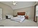 Large main bedroom with vaulted ceilings, carpet flooring, and a seating area at 908 Huntington Pl, Peachtree City, GA 30269