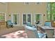 Outdoor living space with comfortable seating arrangements on a wooden deck and trees at 302 Welton Way, Peachtree City, GA 30269