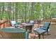 Back deck features comfortable seating, a grill, and a tranquil wooded backdrop at 302 Welton Way, Peachtree City, GA 30269