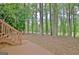 Wooden deck and wooded area with mature trees providing serene backyard views at 302 Welton Way, Peachtree City, GA 30269