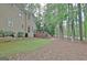 Expansive backyard with a wooden deck, lush greenery, and mature trees for privacy at 302 Welton Way, Peachtree City, GA 30269