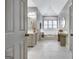 Bright bathroom featuring a vaulted ceiling, white marble floors and a luxurious soaking tub at 302 Welton Way, Peachtree City, GA 30269