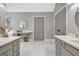 Bathroom with two vanities, bright white marble floor and ample storage space at 302 Welton Way, Peachtree City, GA 30269