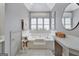 Soaking tub with white tile surround and window with bright natural light at 302 Welton Way, Peachtree City, GA 30269