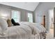 Bedroom featuring a queen-size bed, neutral walls, and large windows at 302 Welton Way, Peachtree City, GA 30269
