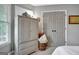 Bedroom with classic decor, featuring a painted armoire, soft carpet, and neutral color palette at 302 Welton Way, Peachtree City, GA 30269