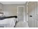 Bedroom featuring gray walls, plush carpet, multiple doors, and neutral accents at 302 Welton Way, Peachtree City, GA 30269