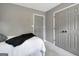 Bedroom featuring gray walls, plush carpet, double doors, and neutral accents at 302 Welton Way, Peachtree City, GA 30269