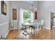 Dining room features hardwood flooring, chandelier and natural light from the adjacent window at 302 Welton Way, Peachtree City, GA 30269