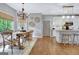 Open dining room showcasing hardwood floors and seamless transition to the kitchen at 302 Welton Way, Peachtree City, GA 30269