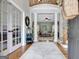 Spacious foyer with hardwood floors, staircase, and columns leading into a bright living area at 302 Welton Way, Peachtree City, GA 30269