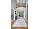 Bright foyer with hardwood flooring, staircase, and columns opening into a well-lit living space at 302 Welton Way, Peachtree City, GA 30269