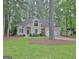 Beautiful beige two-story home with a well-kept front lawn and an attached two-car garage at 302 Welton Way, Peachtree City, GA 30269