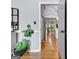 Hallway leads to a modern kitchen area, with hardwood flooring and natural lighting at 302 Welton Way, Peachtree City, GA 30269