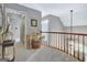 Hallway featuring a wooden banister and neutral colored walls and carpet at 302 Welton Way, Peachtree City, GA 30269