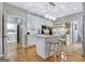 Bright kitchen featuring island seating and seamless transition to laundry area at 302 Welton Way, Peachtree City, GA 30269