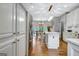 Open kitchen with white cabinets, stainless steel appliances, and dining area beyond at 302 Welton Way, Peachtree City, GA 30269