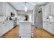Bright kitchen showcasing a central island, modern appliances, and wood floors at 302 Welton Way, Peachtree City, GA 30269
