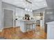 Open kitchen featuring an island with stool seating and views of the white cabinets at 302 Welton Way, Peachtree City, GA 30269