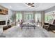 Bright and airy living room with hardwood floors, ceiling fan and access to outdoor patio at 302 Welton Way, Peachtree City, GA 30269