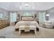 Spacious main bedroom with vaulted ceiling, chandelier, arched window and sitting area at 302 Welton Way, Peachtree City, GA 30269