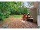 A view of the house from the backyard featuring a wooden deck and a lush green lawn at 142 Pebblebrook Way, Temple, GA 30179