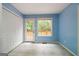 A bedroom with blue walls, tile flooring, white trim and a closet at 142 Pebblebrook Way, Temple, GA 30179