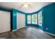 Bright bedroom featuring hard floors, blue walls, and natural light from the three windows at 142 Pebblebrook Way, Temple, GA 30179
