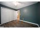A bedroom with modern vinyl flooring and a spacious closet at 142 Pebblebrook Way, Temple, GA 30179