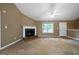 Cozy living room featuring a fireplace and bright windows at 142 Pebblebrook Way, Temple, GA 30179