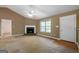 Comfortable living room featuring a fireplace and bright windows at 142 Pebblebrook Way, Temple, GA 30179