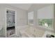 Relaxing bathroom featuring a jacuzzi tub, natural light, and neutral tones at 40 Salem Ct, Mcdonough, GA 30252