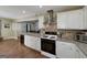 Well-equipped kitchen with stainless steel appliances, white cabinetry, and stylish tile backsplash at 40 Salem Ct, Mcdonough, GA 30252