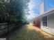 View of the backyard with a wooden fence and covered patio at 6190 Winston Trce, Mcdonough, GA 30252