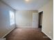 Bedroom with neutral carpet and a window allowing natural light at 6190 Winston Trce, Mcdonough, GA 30252