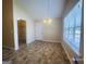 The dining room has tiled floors and a chandelier and is well-lit from the natural light coming from the window at 6190 Winston Trce, Mcdonough, GA 30252