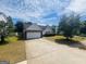 Home featuring a spacious driveway, attached garage, and a neatly landscaped front yard at 6190 Winston Trce, Mcdonough, GA 30252