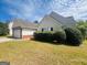 View of a home showcasing manicured landscaping and a side-entry garage at 6190 Winston Trce, Mcdonough, GA 30252