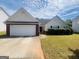 Charming home with a well-maintained lawn and attached garage, perfect for suburban living at 6190 Winston Trce, Mcdonough, GA 30252