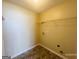 Compact laundry room area with utility connections and wire rack shelving for storage at 6190 Winston Trce, Mcdonough, GA 30252